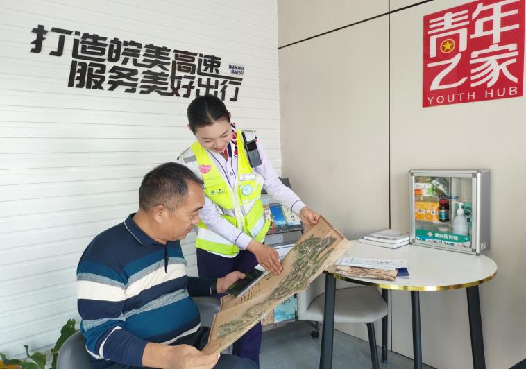 黄山中心黟县站员工吕春芳向过往司乘推荐旅游路线。安徽交控集团黄山管理中心供图